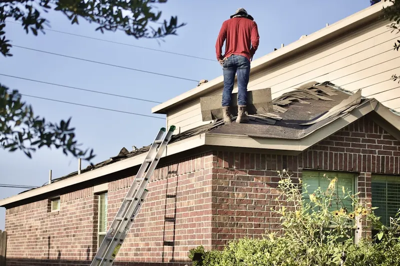 Professional roofer working on a residential roof in Webb City